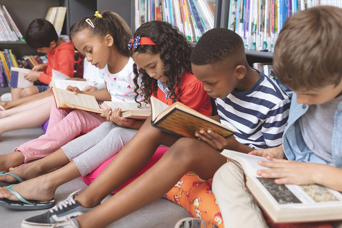 Children reading books in library