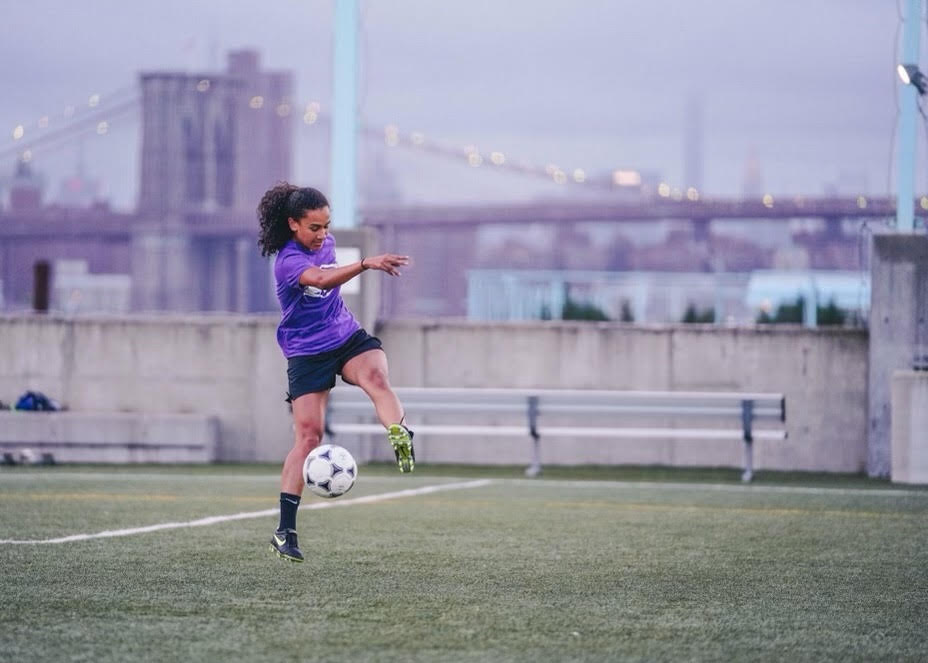 Shani playing soccer outside