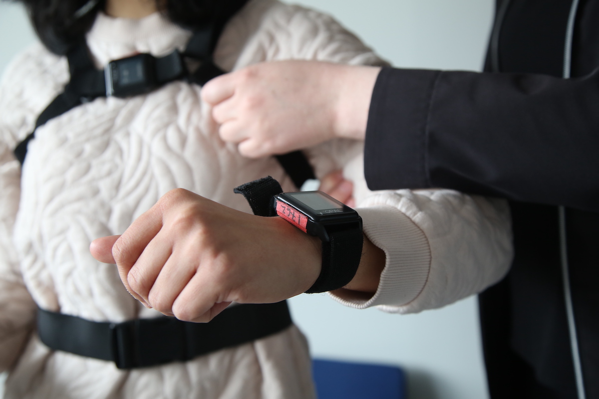 monitoring bracelet on patient with practicioner