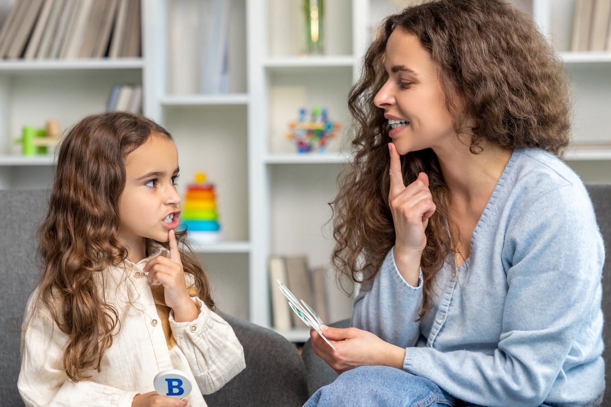 Speech pathologist works with young patient