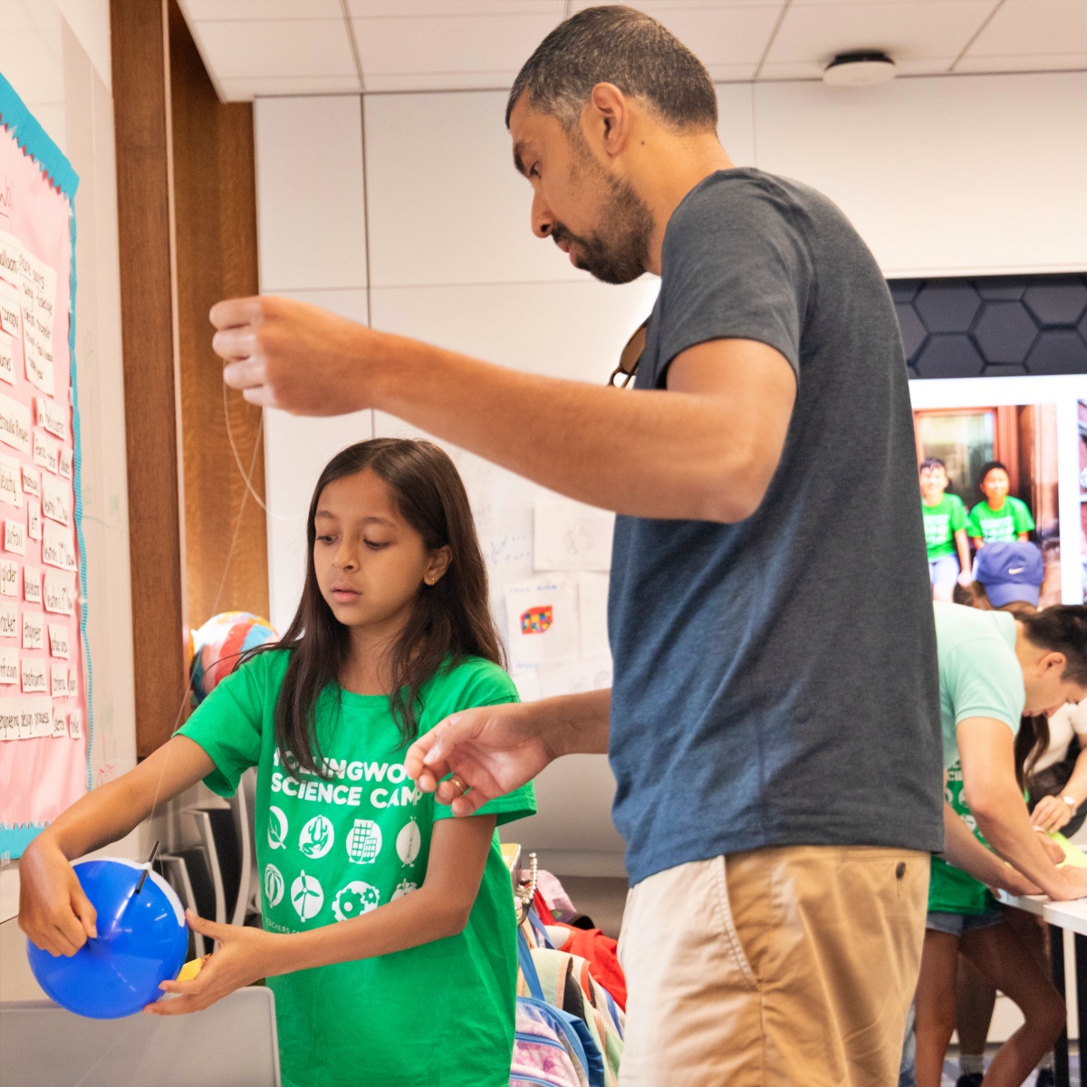A camper demonstrates a pulley system.