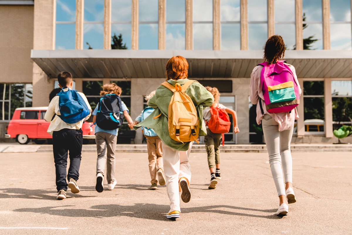 students running to the school building for classes