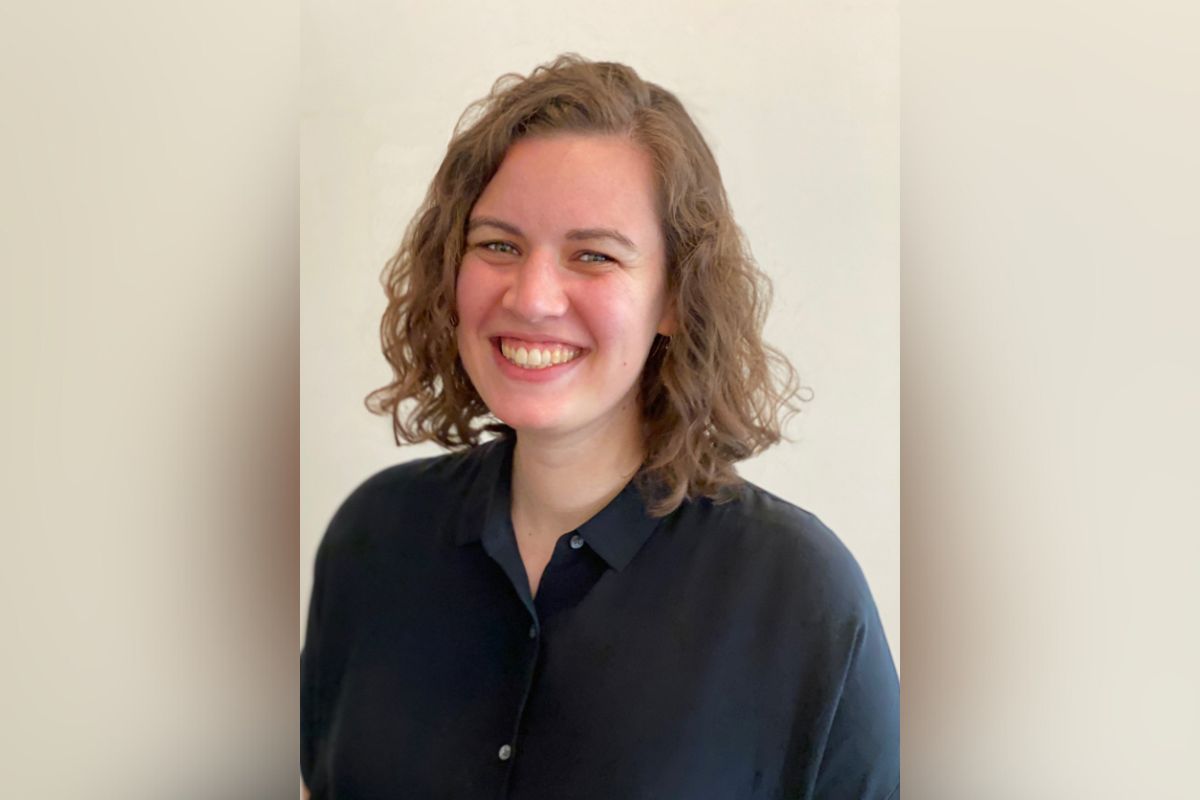 Rachel Klepped, a woman with fair skin and shoulder length wavy hair, wearing a black button down shirt