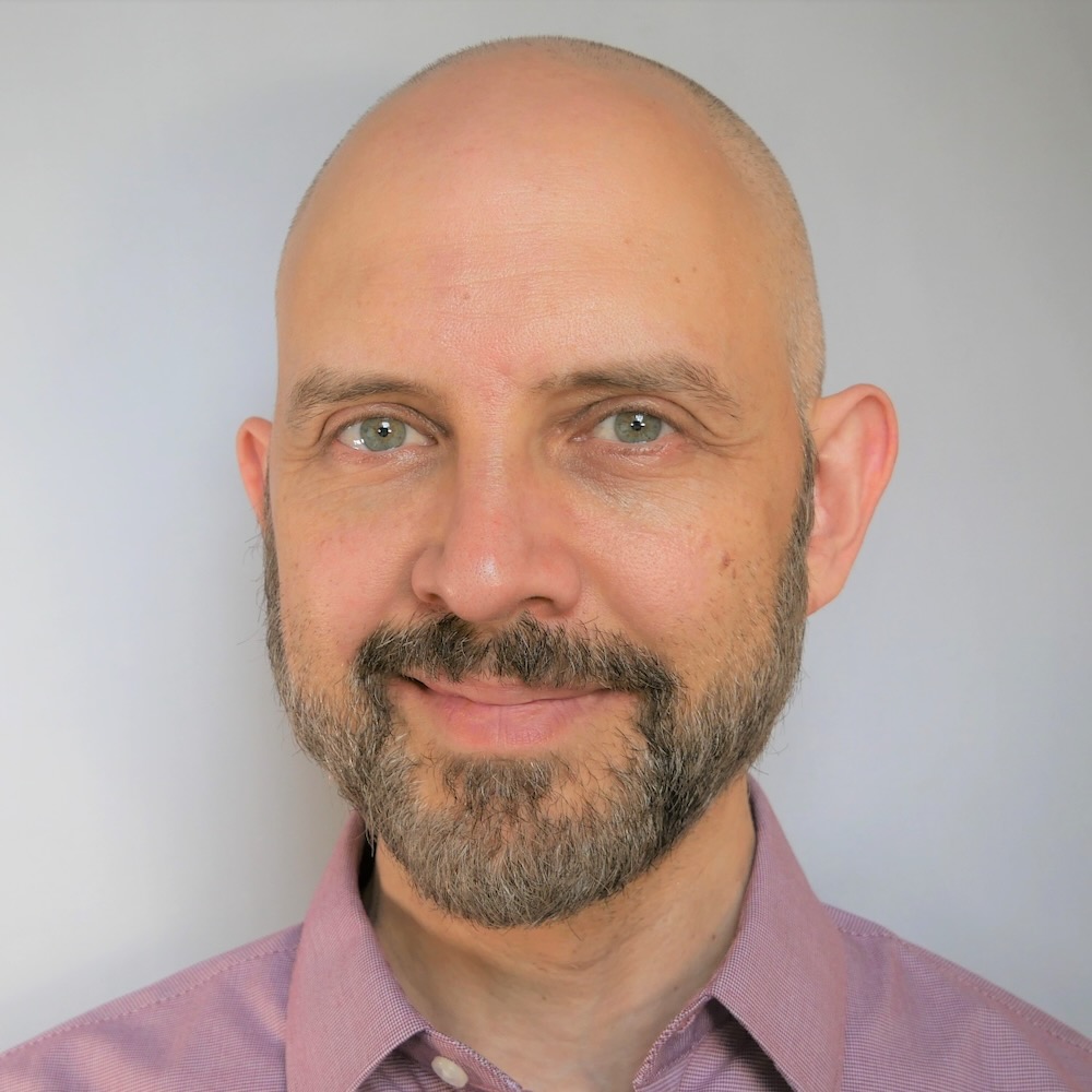 Paulo Blikstein, a bald man with a beard, smiles softly