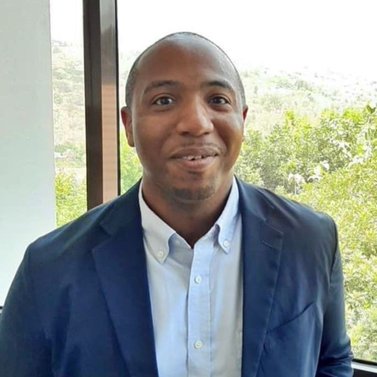 Kevin Henderson smiling in a blazer