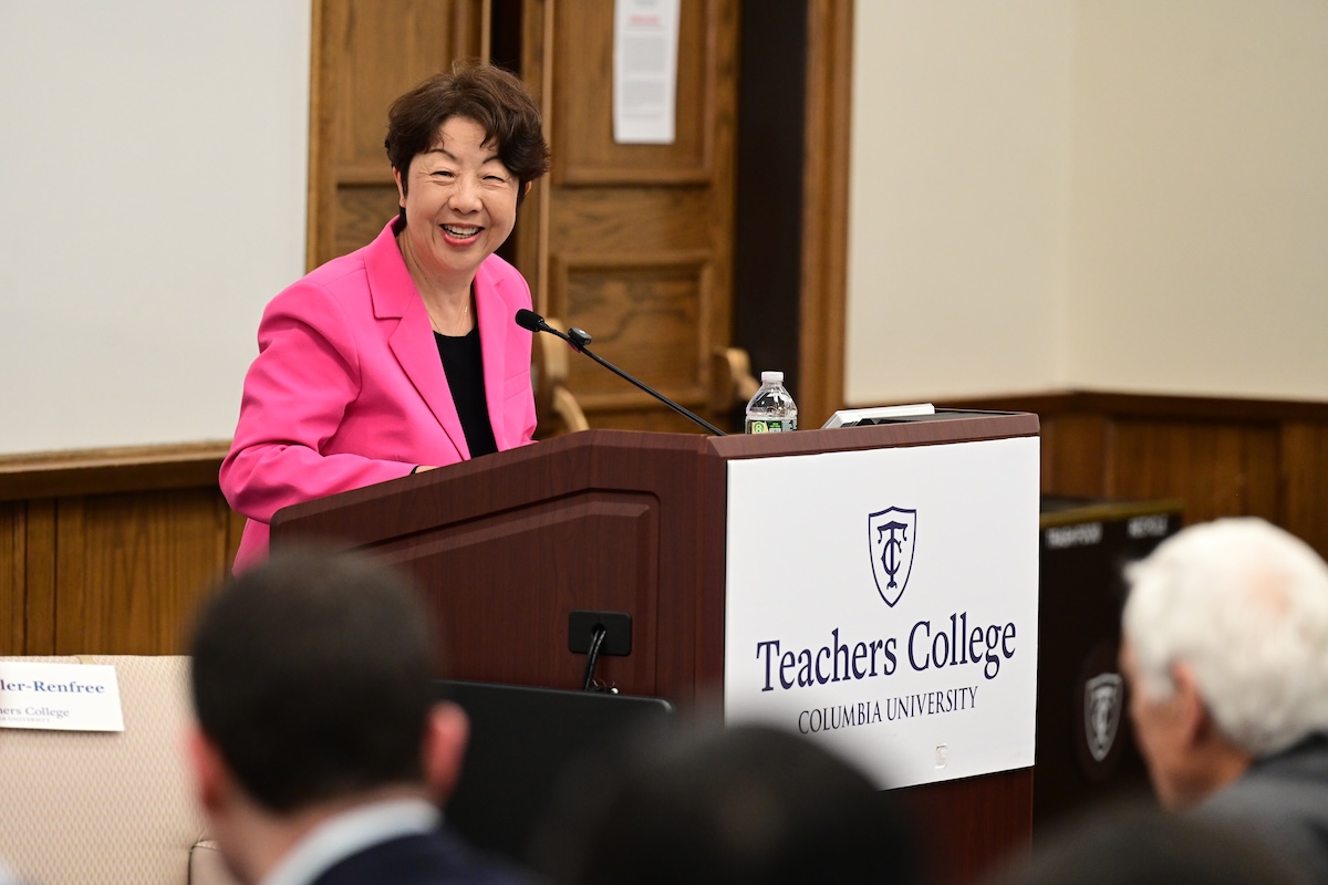 Xiaodong speaks at podium