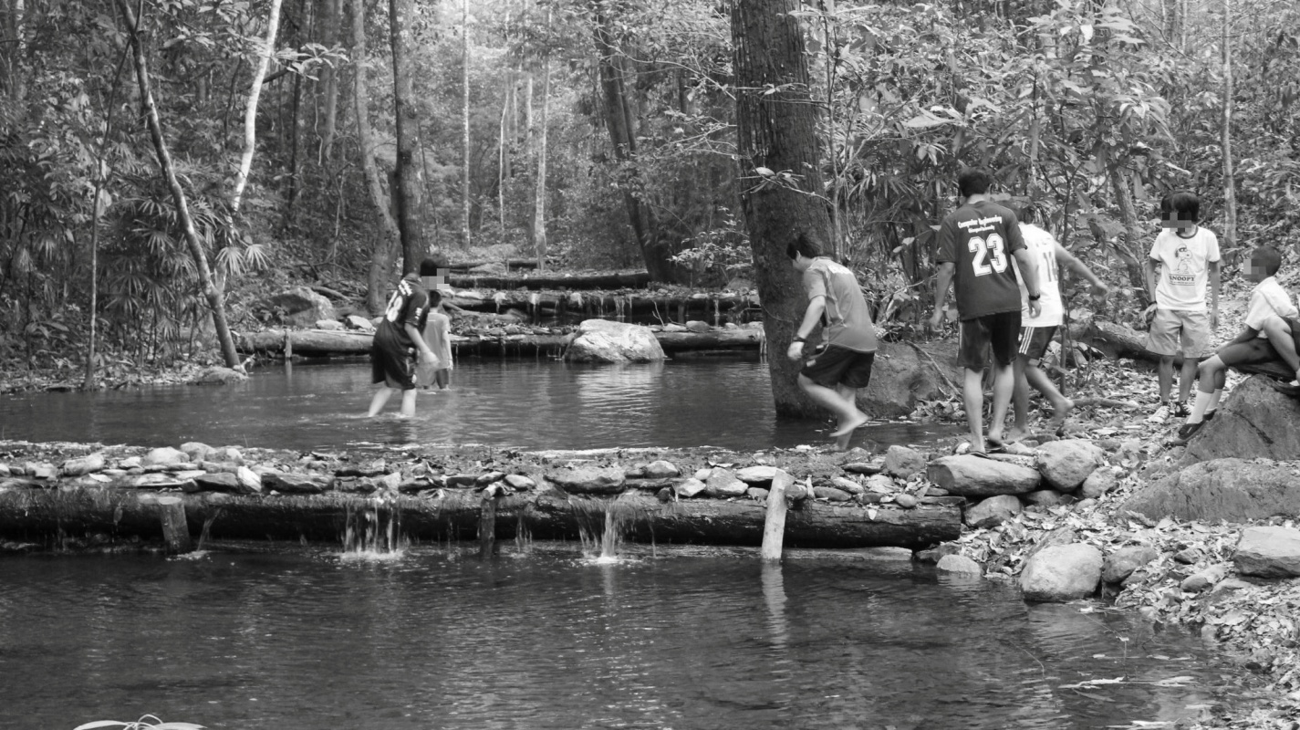 Thai students playing in creek