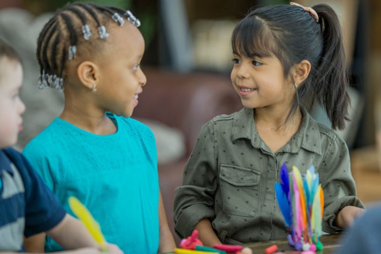 Two Kids smiling at each other