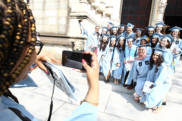 Graduates posing for a photograph outside of Convocation