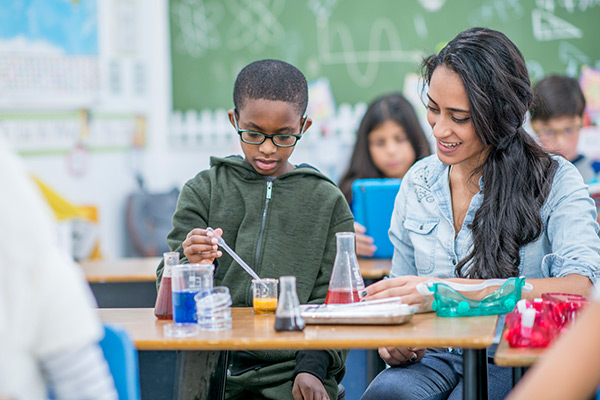 Teacher and student in science class